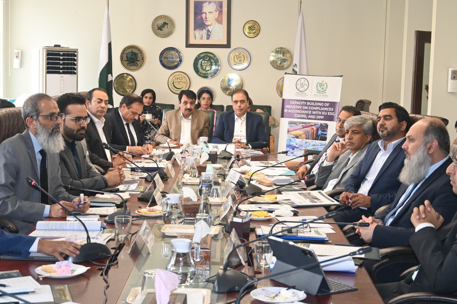 Conference meeting with participants around a table with blue flowers